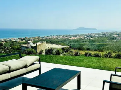 a couch and a table on a patio with a view at Skyline Serenity Villa 10 people 4bedroom 3ba, 3min To Beach in Maleme