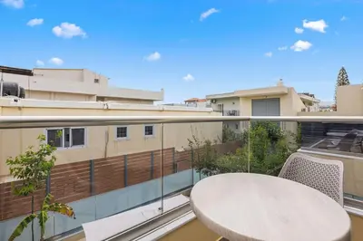 a balcony with a table and chairs on a building at Park and sea view Villa with Private Pool 2 in Chania Town