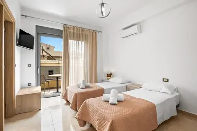 a bedroom with two beds and a balcony at Park and sea view Villa with Private Pool 2 in Chania Town