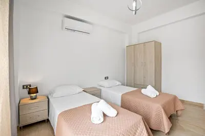 a bedroom with two beds with towels on them at Park and sea view Villa with Private Pool 2 in Chania Town