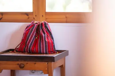 a red bag sitting on a table next to a window at BABIS & POPI APARTMENTS in Frangokastello