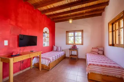 a room with red walls and a desk and a tv at BABIS & POPI APARTMENTS in Frangokastello