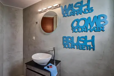 a bathroom with a sink and a mirror at Mons Villa in Kalathas