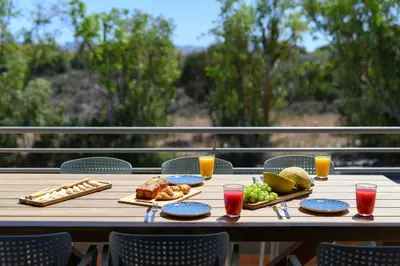a wooden table with food and drinks on it at Mons Villa in Kalathas