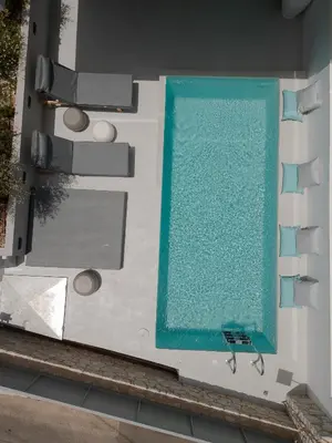 an overhead view of a swimming pool on a building at Athos Guesthouse in Stalos