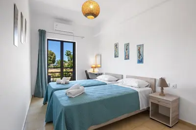 a bedroom with two beds and a window at Sun Beach Apartment in Chania 3 in Chania Town