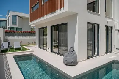 a house with a pool and a statue next to a house at P Project Houses in Aghii Apostoli