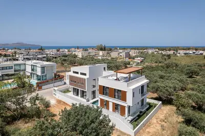 an aerial view of a white building with trees at P Project Houses in Aghii Apostoli
