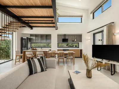 a living room with a couch and a dining room at P Project Houses in Aghii Apostoli