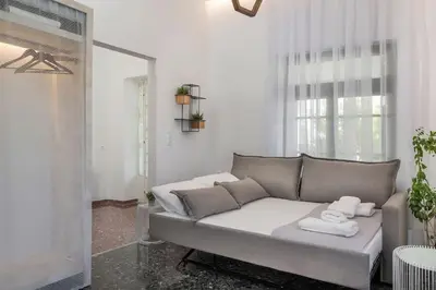 a living room with a couch and a window at Casa Αrezio in Chania Town