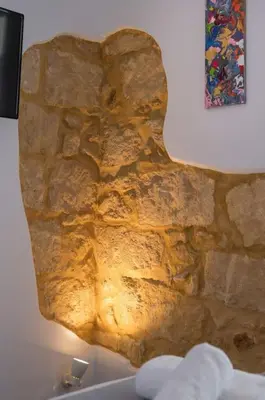 a rock wall with a picture on the wall at Casa Αrezio in Chania Town