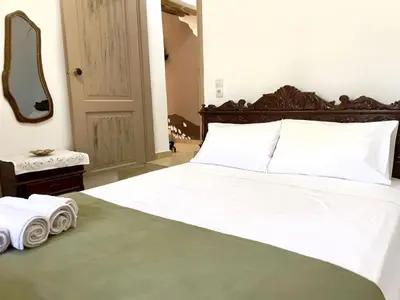 a bedroom with a white bed with two towels on it at Kyparissos Apartment II in Kissamos