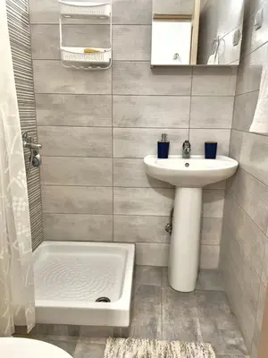 a small bathroom with a sink and a toilet at Kyparissos Apartment II in Kissamos