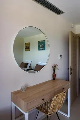 a mirror on a wall with a table and a room at Upper View Villa, with private pool in Chania Town