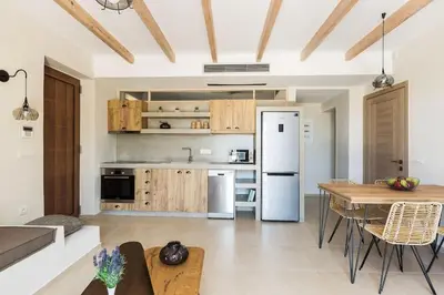 a kitchen with a white refrigerator and a table at Upper View Villa, with private pool in Chania Town