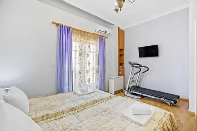 a bedroom with a bed and a treadmill at Artistic Apartment in Chania in Chania Town