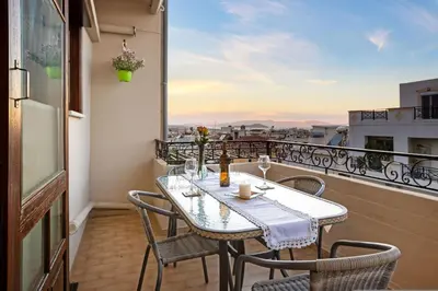 a table and chairs on a balcony with a view at Artistic Apartment in Chania in Chania Town