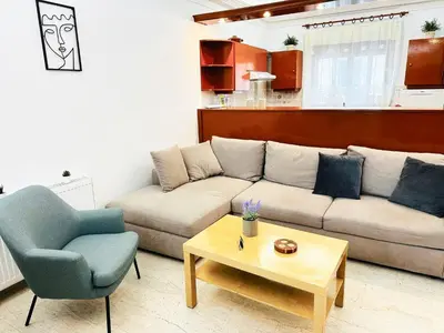 a living room with a couch and a table at Sea Breeze Sanctuary-1bd 3pl 1ba - 90m To Sea in Chania Town