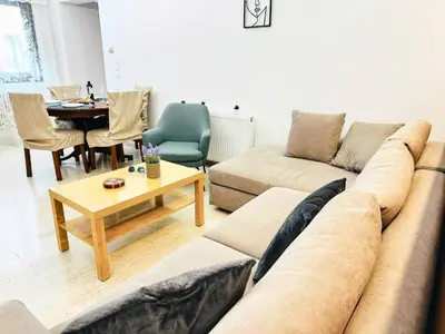 a living room with a couch and a table at Sea Breeze Sanctuary-1bd 3pl 1ba - 90m To Sea in Chania Town