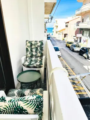 a balcony with two chairs and a table and a street at Sea Breeze Sanctuary-1bd 3pl 1ba - 90m To Sea in Chania Town