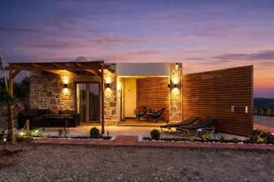a small house with a patio at night at Holy Sea Smart Suites in Elafonisi