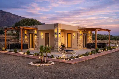 a house in the desert at night with lights at Holy Sea Smart Suites in Elafonisi