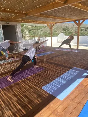 a group of people doing yoga in a pavilion at Infinity Wellness Boutique Hotel in Afráta