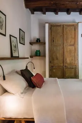 a bedroom with two beds and a wooden door at Μilia Mountain retreat in Vlátos