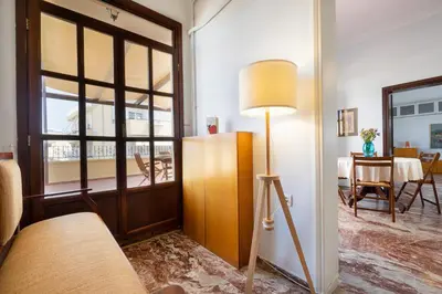 a living room with a floor lamp and a table at Clio Townhouse in Chania Town