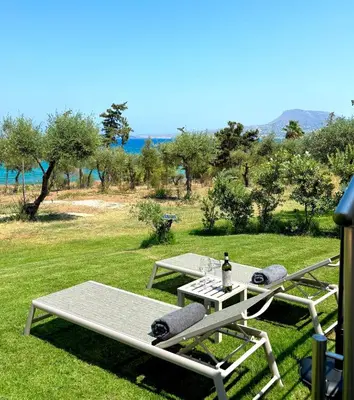 a picnic table with a bottle of wine on it at Terra Blue Suites - Dimitra in Kalyves