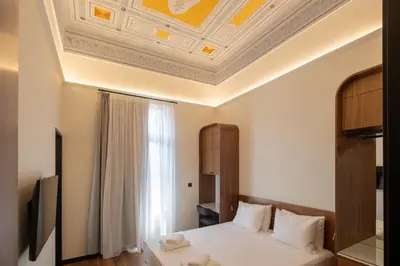 a bedroom with a bed and a coffered ceiling at Bouquet Luxury Rooms in Chania Town