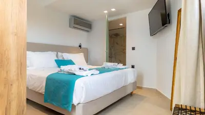 a bedroom with a bed with towels on it at D PALM Premium Living - Kalathas, Chania in Chania Town