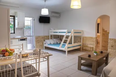 a living room with two bunk beds and a kitchen at Maria's House in Chania in Kounoupidhianá