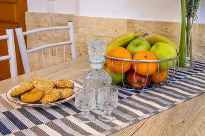 a basket of fruit on a table with a bowl of fruit at Maria's House in Chania in Kounoupidhianá