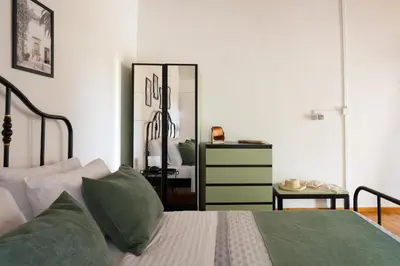 a bedroom with a bed and a dresser and a mirror at liofito village house in Pemónia