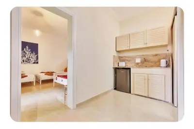 a room with a kitchen and a living room at Cretan Fun in Stalos