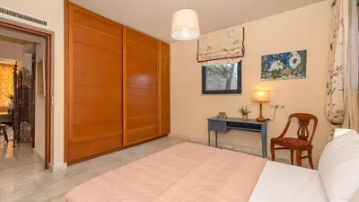 a bedroom with a bed and a desk with a chair at Lithos Serenity in Argoulidhés