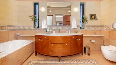 a bathroom with a sink and a tub and a toilet at Lithos Serenity in Argoulidhés