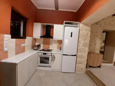 a kitchen with a white refrigerator and a stove at Pool Villa Kamara Crete - Chania in Chania Town