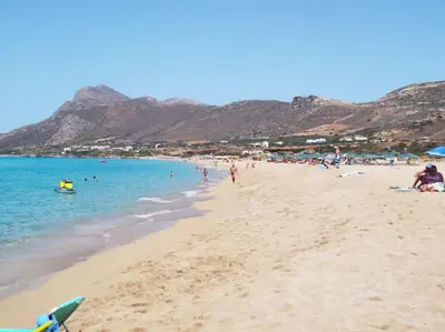 a beach with a bunch of people in the water at Pool Villa Kamara Crete - Chania in Chania Town