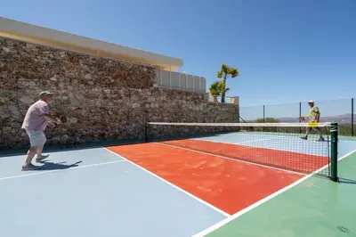 a man playing tennis on a tennis court at Villa Athena - Crete Pickleball Paradise in Vamos
