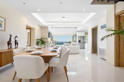 a dining room and living room with a table and chairs at Villa Athena - Crete Pickleball Paradise in Vamos