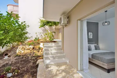 a bedroom with a bed and stairs leading to a porch at La Fleur in Chania Town