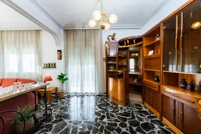 a living room with a couch and a chandelier at Chania Dream House in Chania Town