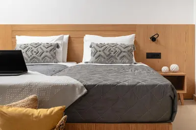 a bedroom with two beds with a laptop on it at Elia City Apartments in Chania Town