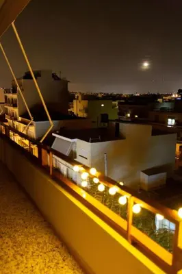 a row of lights on a balcony of a building at night at Κidonias home in Chania Town