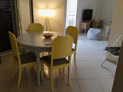 a dining room table with chairs and a lamp on it at Κidonias home in Chania Town