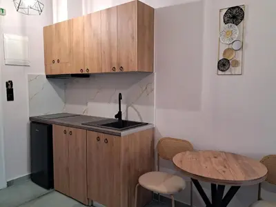 a small kitchen with a sink and a table at Poppy Beloni in Chania Town