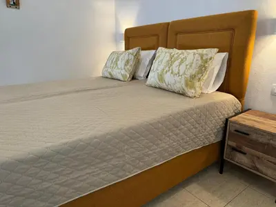 a bed with two pillows on it in a room at Sofia Rooms in Palaiochóra
