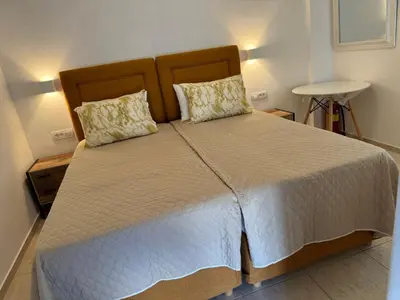 a bedroom with a large bed with white sheets and pillows at Sofia Rooms in Palaiochóra